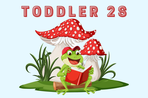 Toddler 2s green frog with red hat sitting on a log under a mushroom reading a book