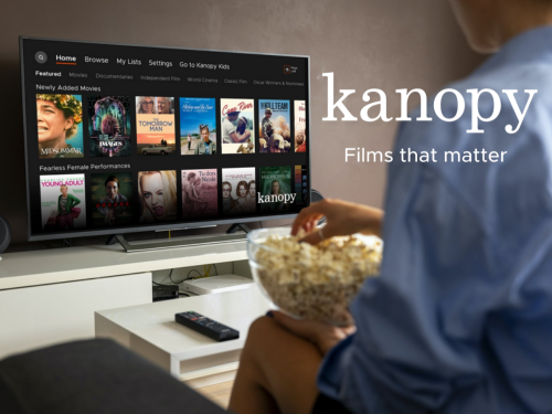 Person watching Kanopy on Smart TV while holding popcorn